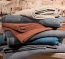 Wende-Kuscheldecke in warmer Farbstellung Heimdecke in der Farbe rot mit einer orangenen Rückseite