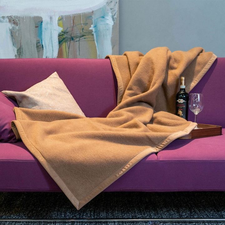Wolldecke aus Baby-Kamelhaar in Farbe kamel, ausgebreitet auf einem Sofa Wolldecke aus Baby-Kamelhaar in Farbe kamel, ausgebreitet auf einem Sofa